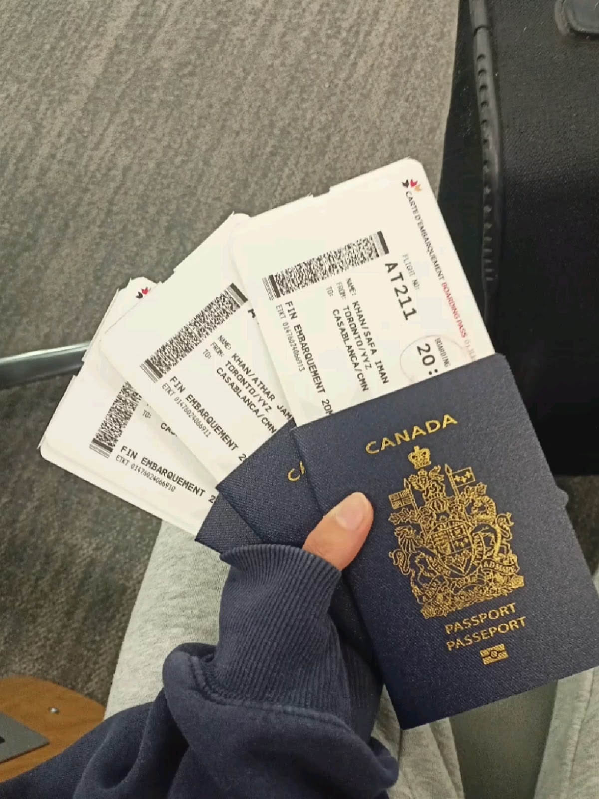 Travel documents and a Canadian passport in an airport setting